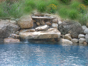 Beautiful Swimming Pool Designs with Travertine Pavers and Waterfall