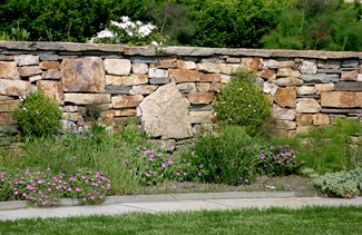 Natural stone wall with boulders.