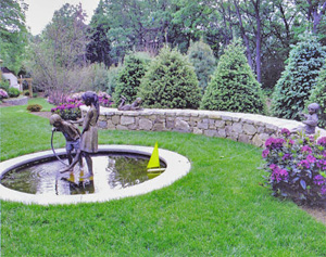 A fountain near a lovely hardscape wall