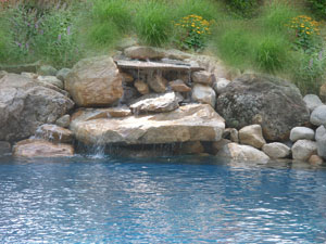 Natural stone waterfall at pool.