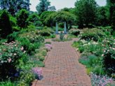English gardens with brick walkway.