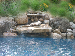 Waterfall designs are attractive at a pool.